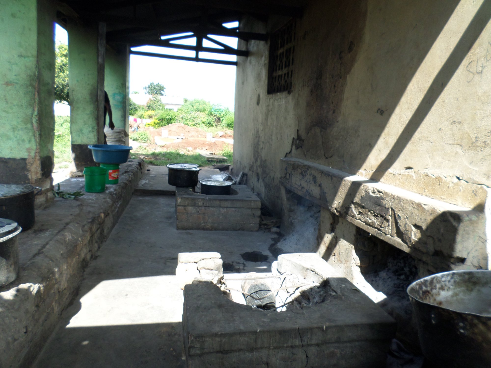 Inside the open cooking area — multiple crumbling stove platforms